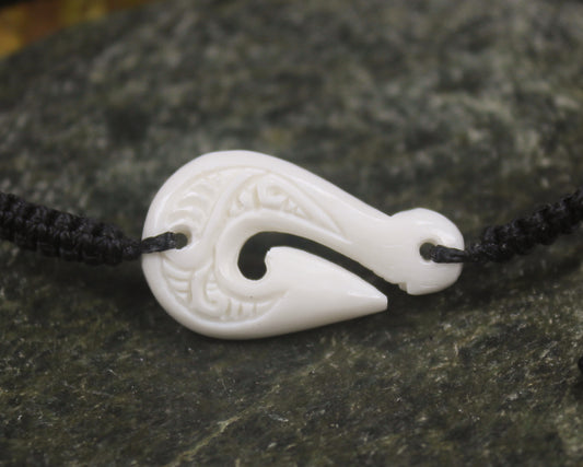 Adjustable cord bracelet with bone pendant