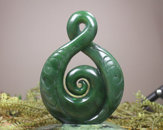 Kawakawa Pounamu Koru Twist set on a Pounamu base - NZ Greenstone