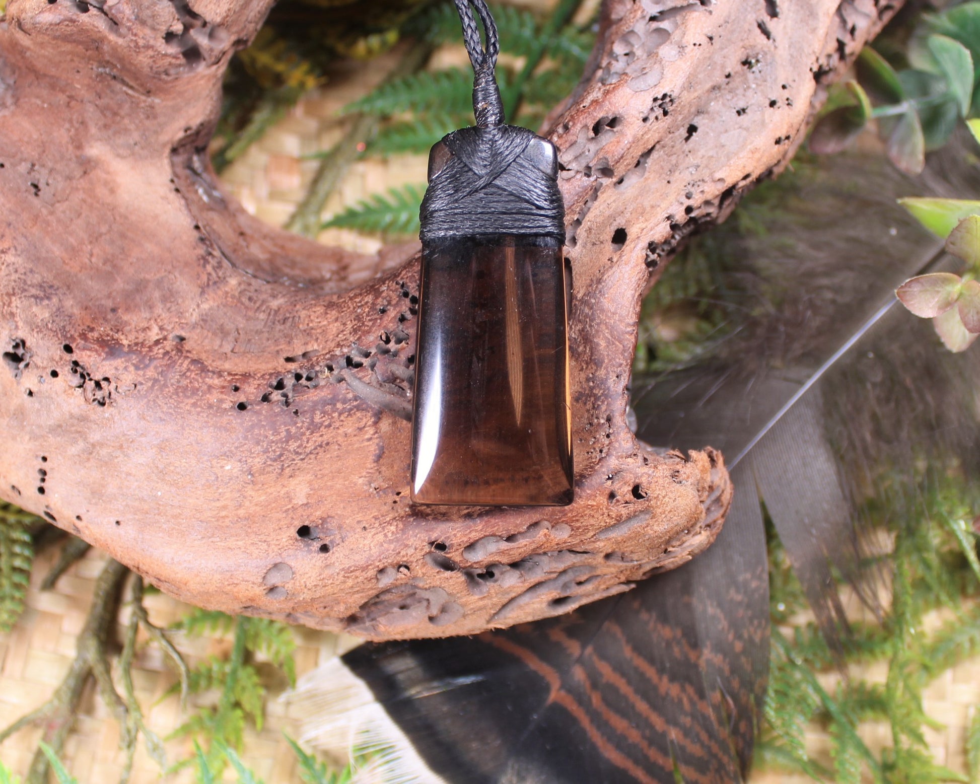 Toki pendant carved from Smokey Quartz