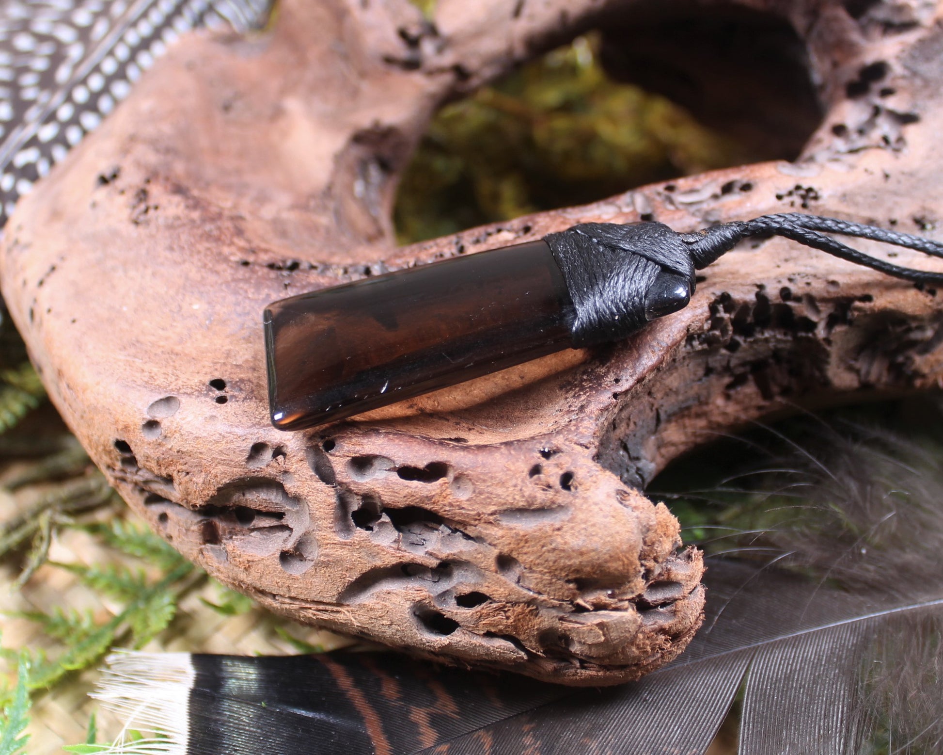 Toki pendant carved from Smokey Quartz