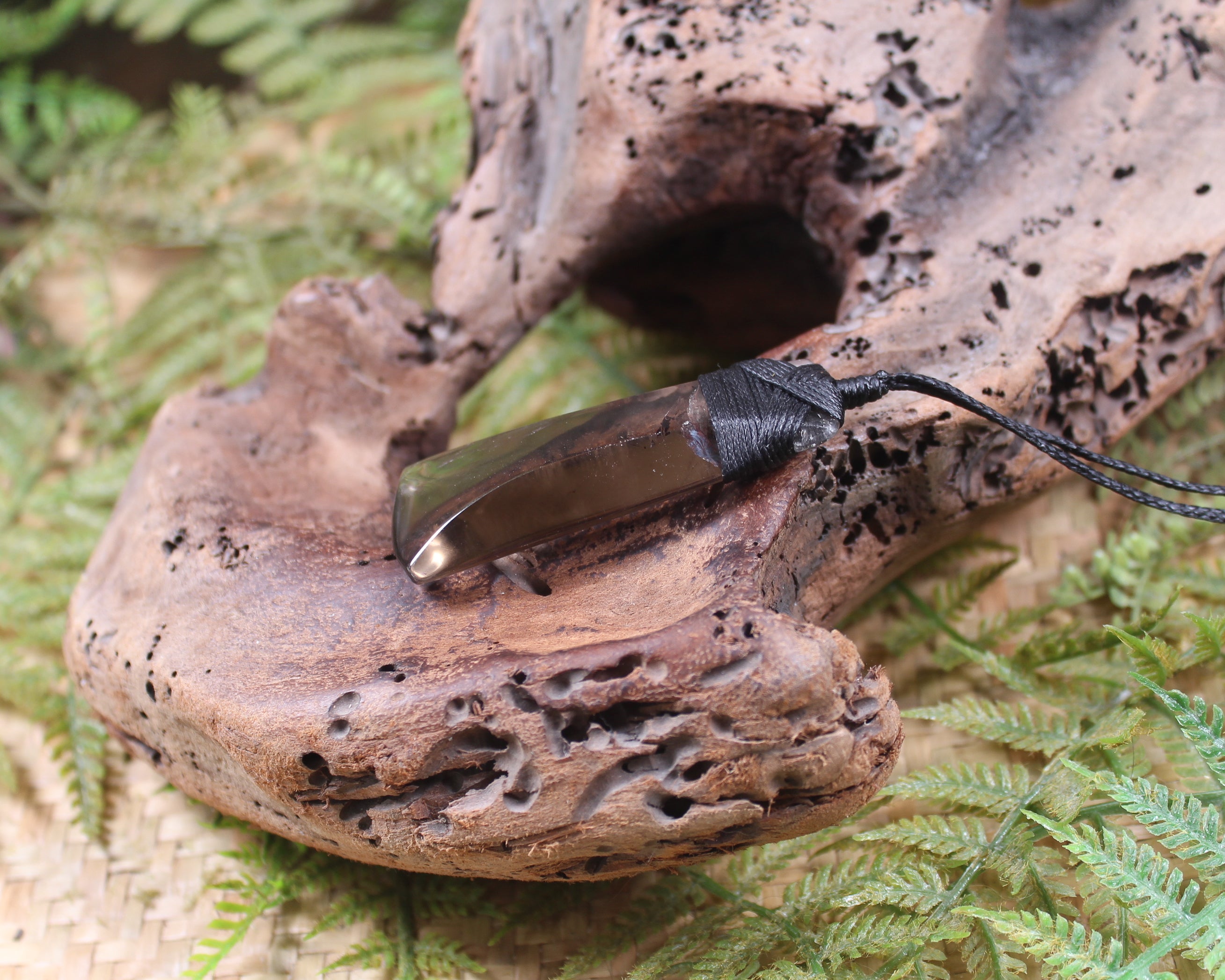 Toki pendant carved from Smokey Quartz