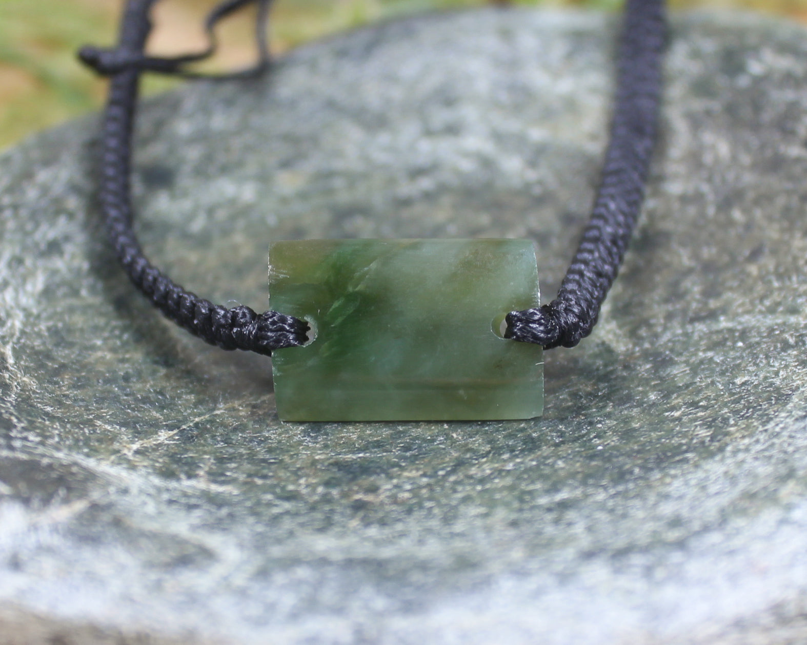 Adjustable cord bracelet with Inanga Pounamu