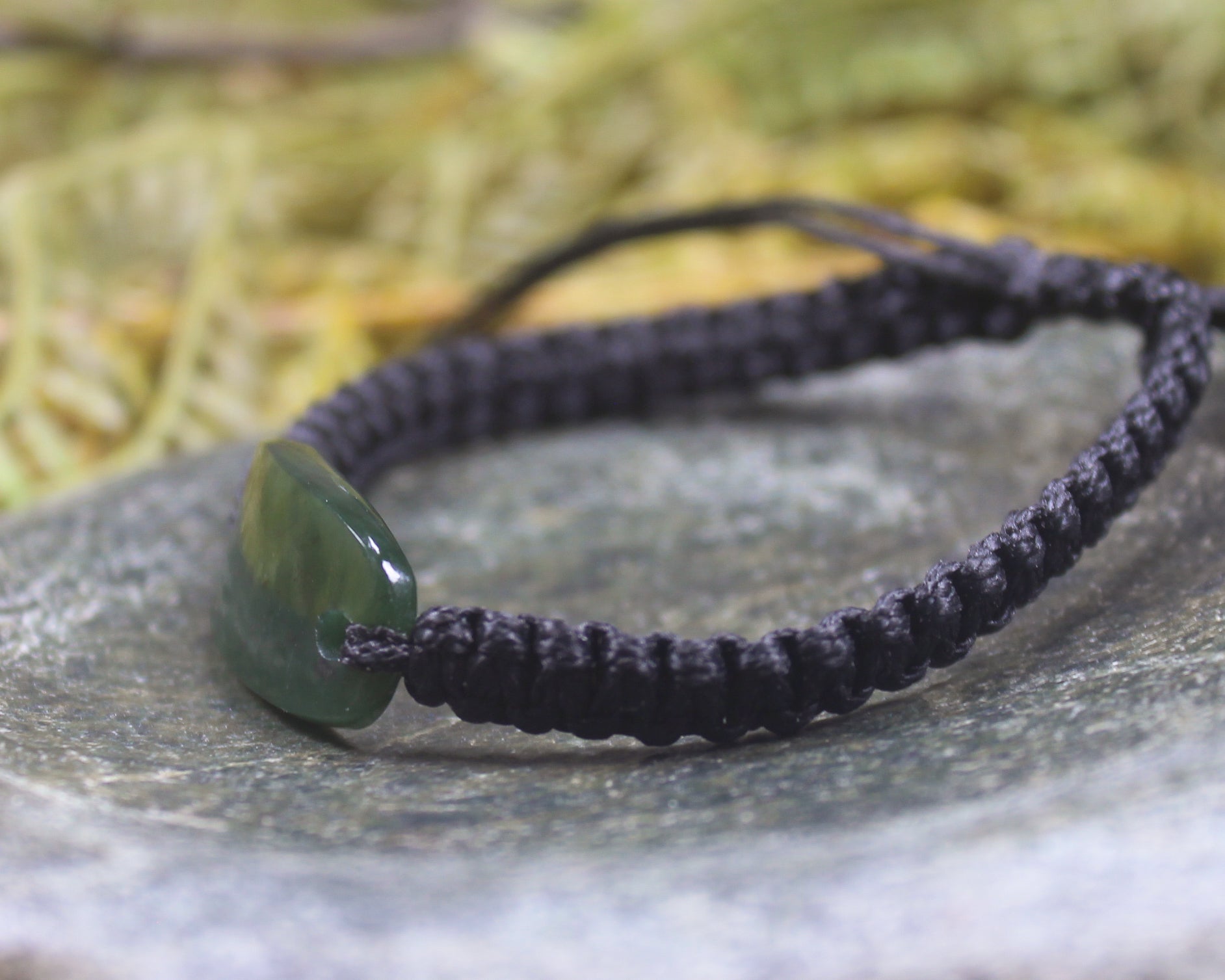 Adjustable cord bracelet with Kawakawa Pounamu