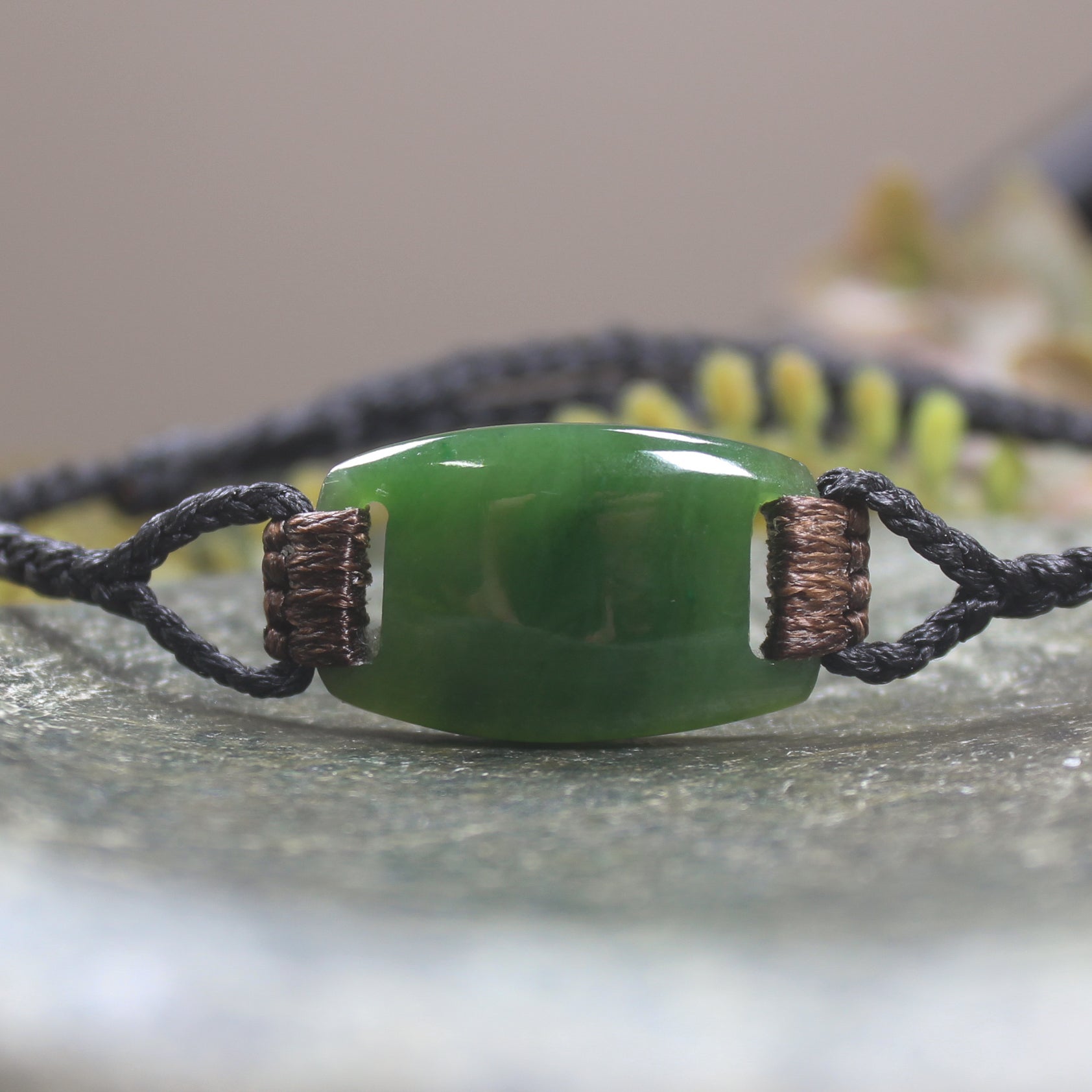 Adjustable cord bracelet with Kawakawa Pounamu