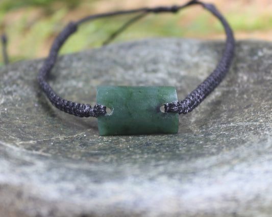 Adjustable cord bracelet with Rimu Pounamu