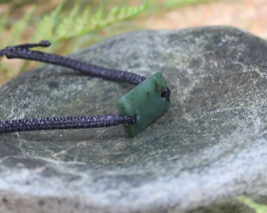 Adjustable cord bracelet with Rimu Pounamu