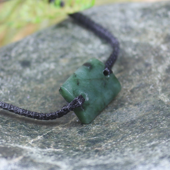Adjustable cord bracelet with Rimu Pounamu