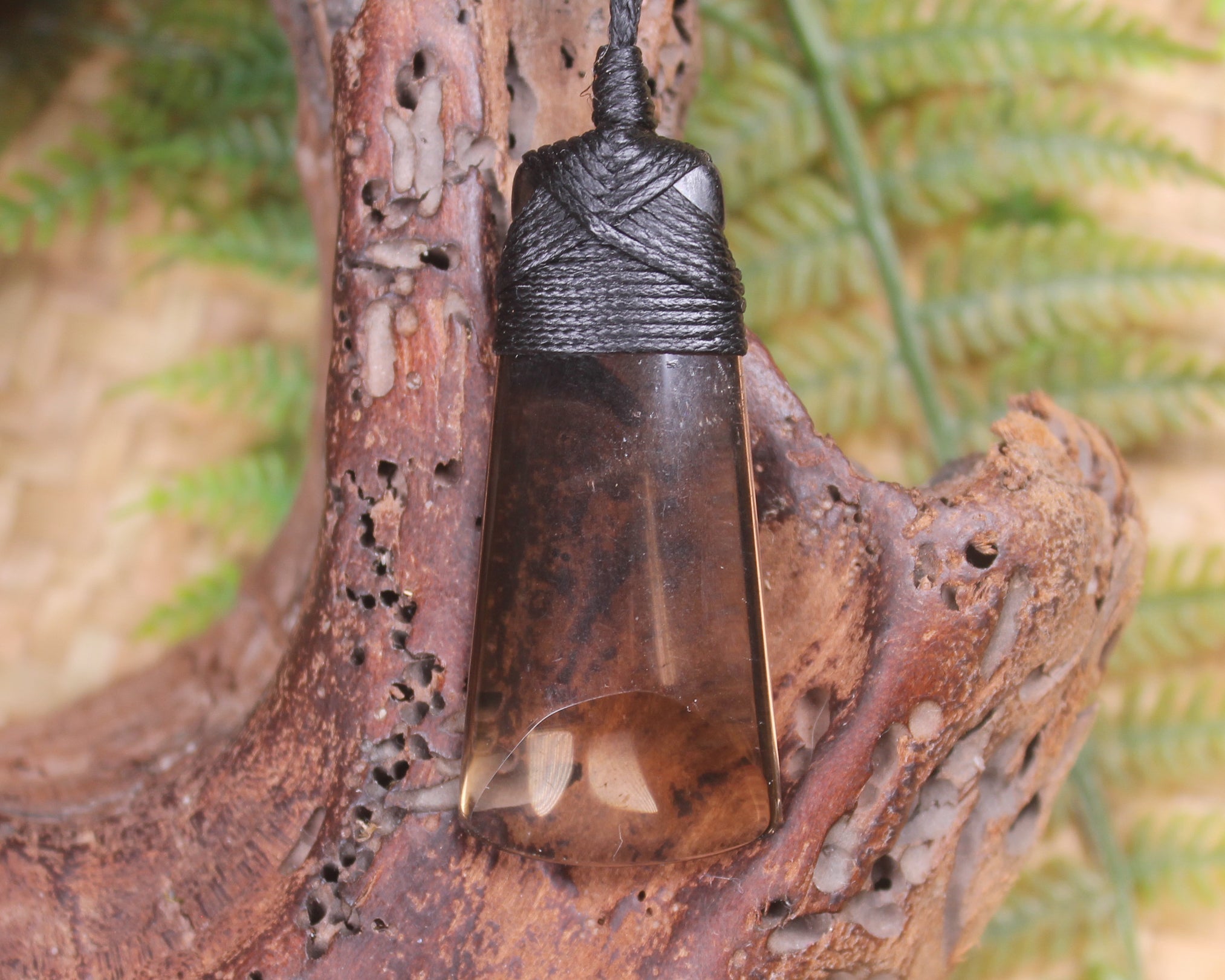 Toki pendant carved from Smokey Quartz