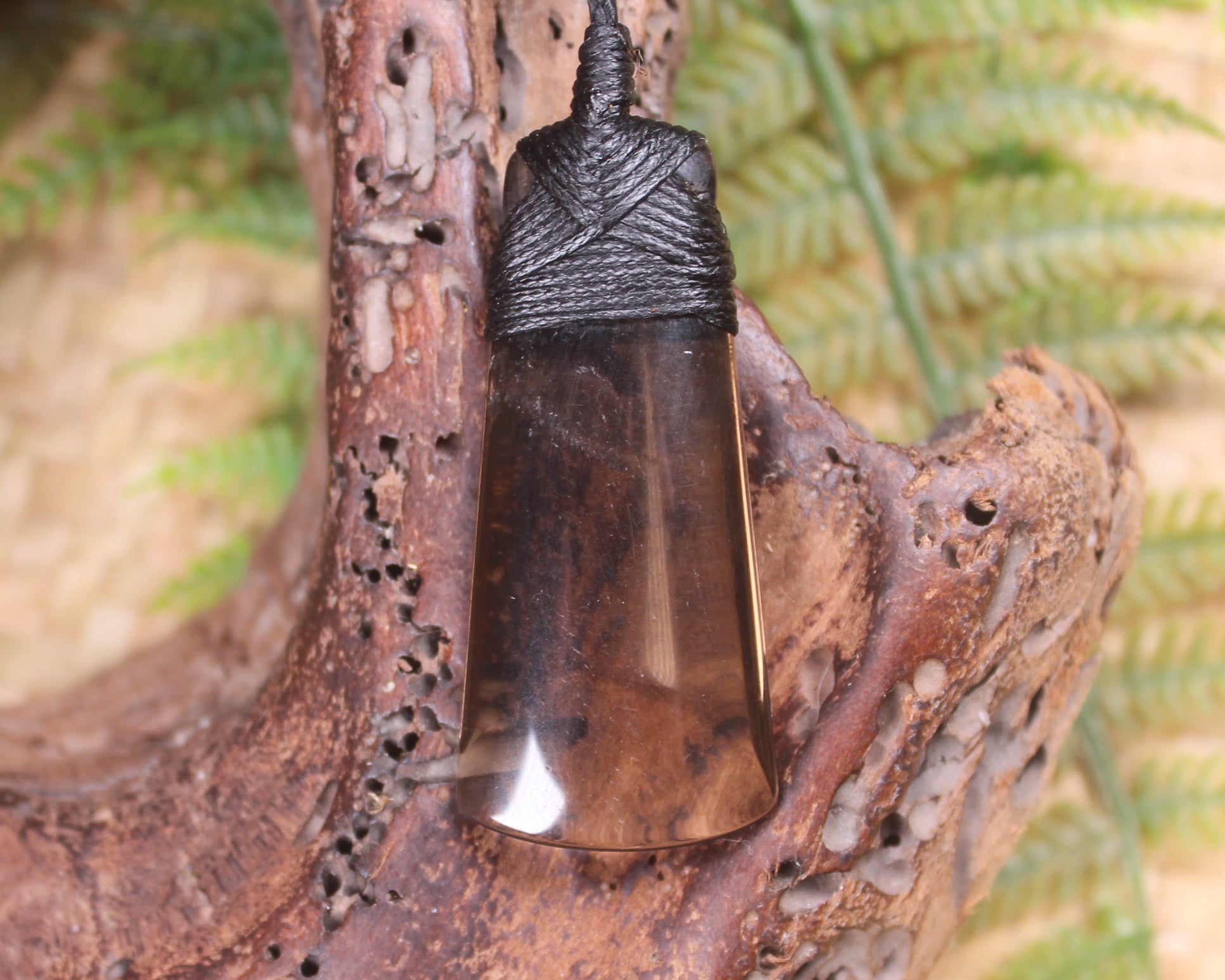 Toki pendant carved from Smokey Quartz