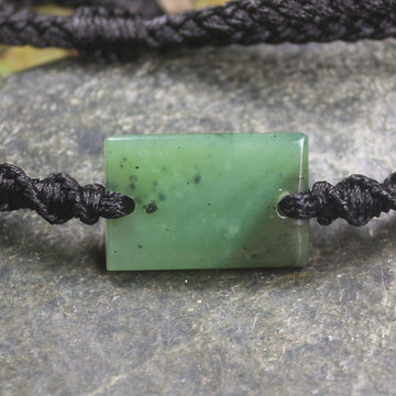 Adjustable cord bracelet with Hapopo Pounamu
