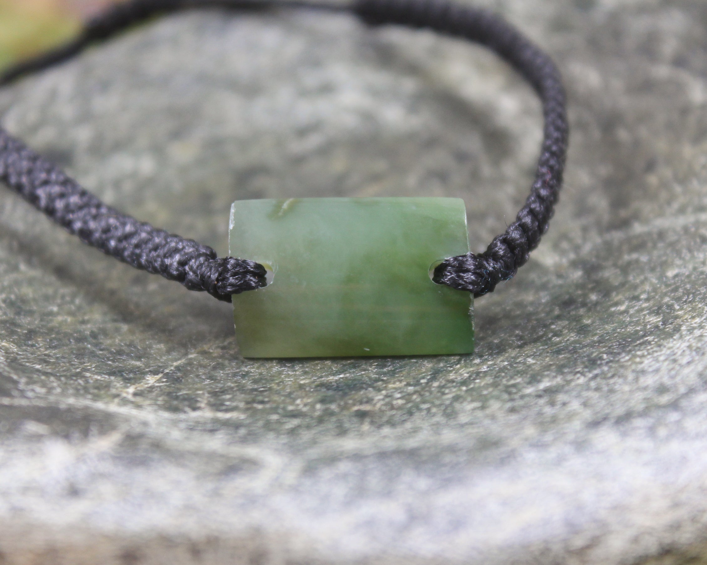 Adjustable cord bracelet with Inanga Pounamu