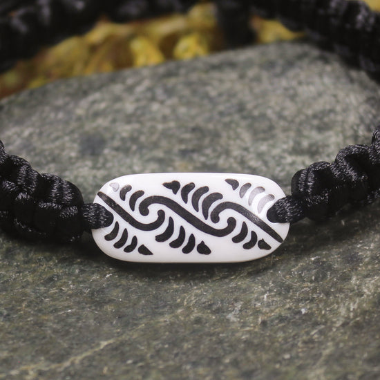 Adjustable cord bracelet with bone pendant