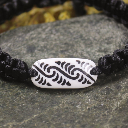 Adjustable cord bracelet with bone pendant