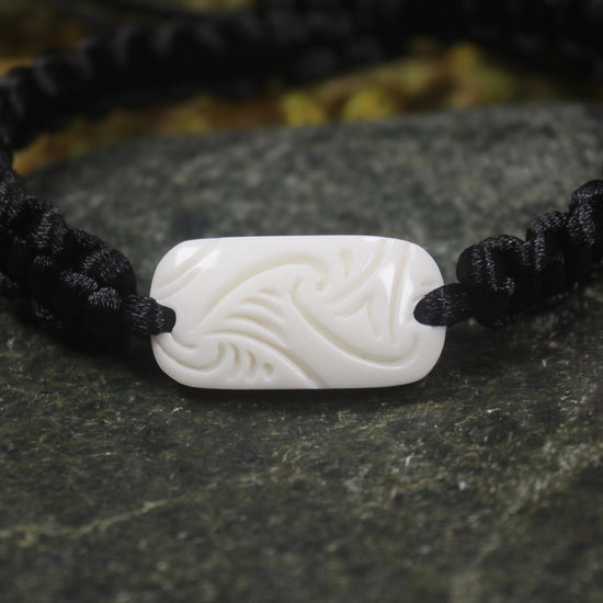 Adjustable cord bracelet with bone pendant
