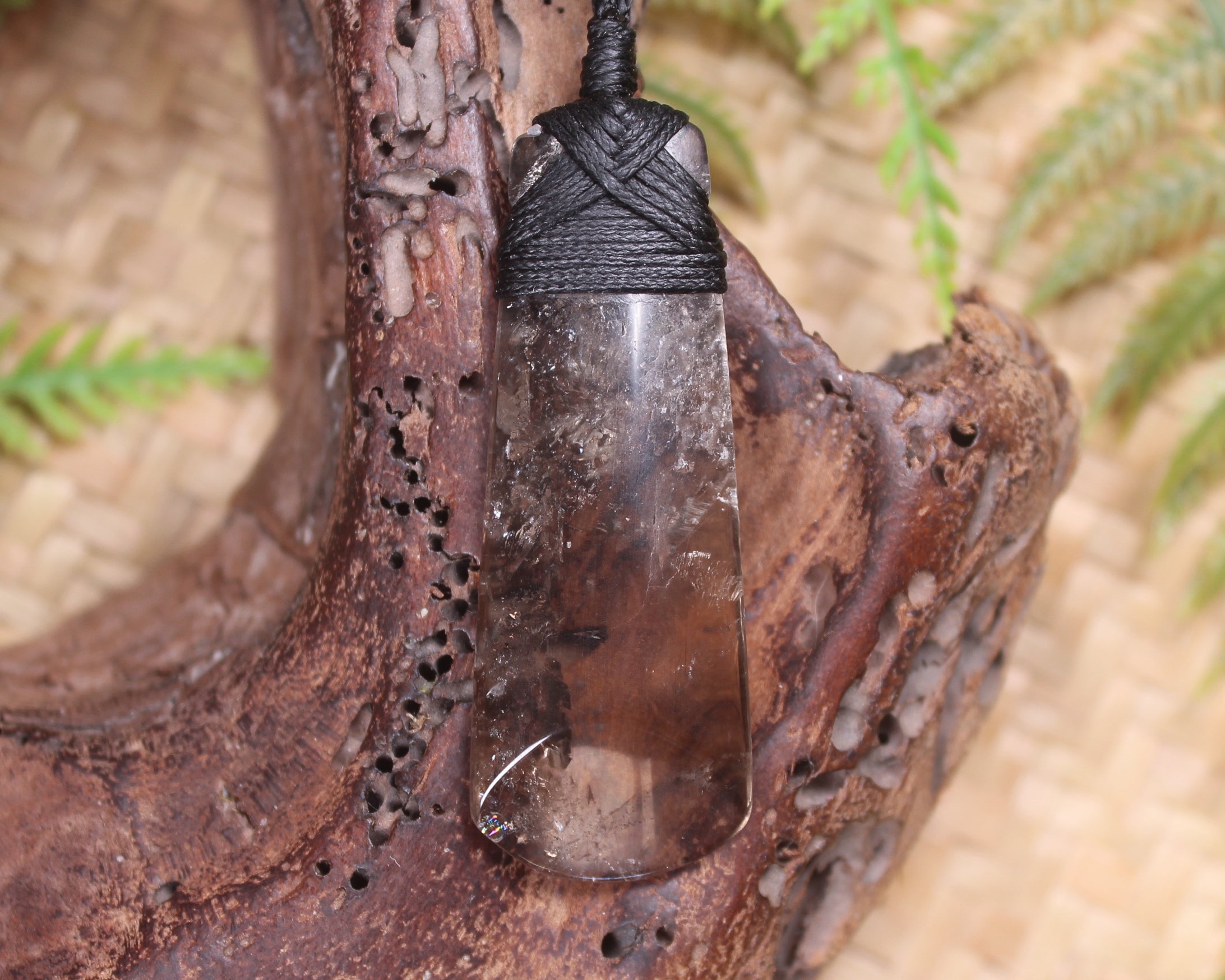 Toki pendant carved from Smokey Quartz