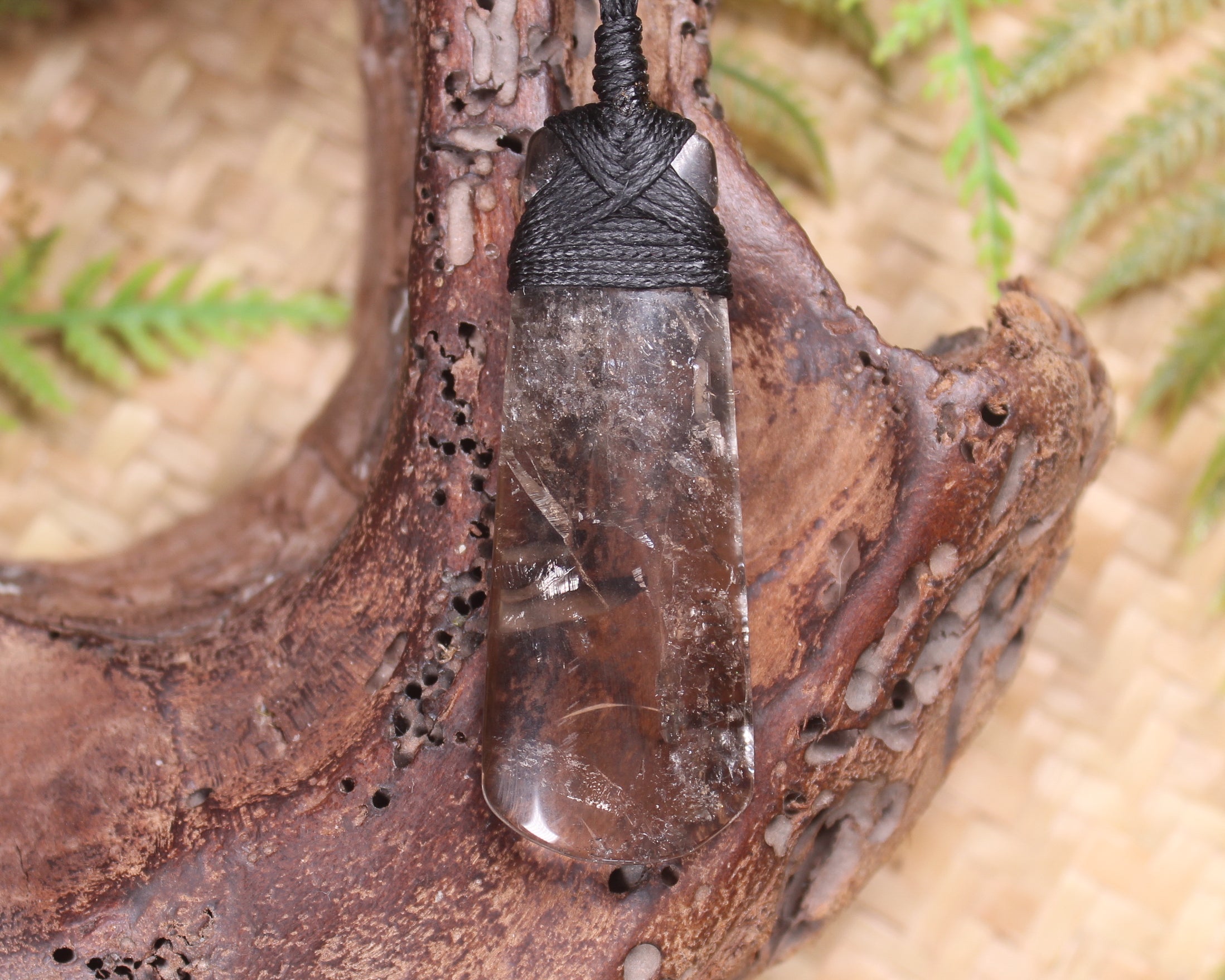 Toki pendant carved from Smokey Quartz