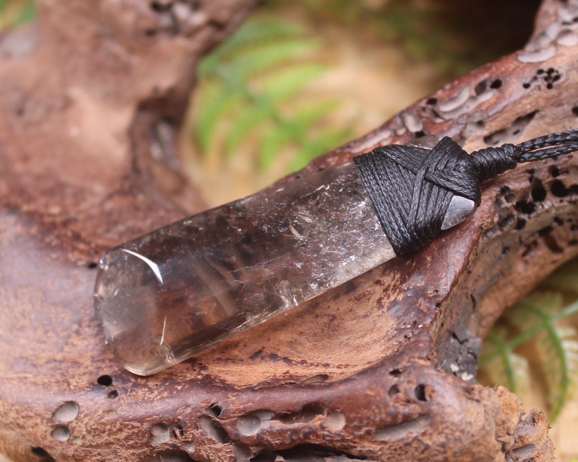 Toki pendant carved from Smokey Quartz