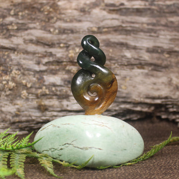 Flower Jade Pounamu Koru Twist set on a Pounamu base - NZ Greenstone