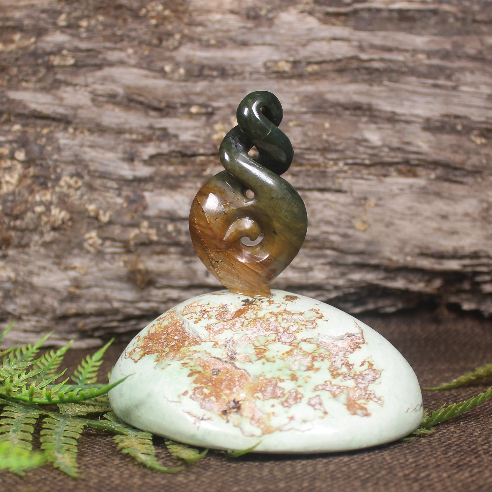 Flower Jade Pounamu Koru Twist set on a Pounamu base - NZ Greenstone