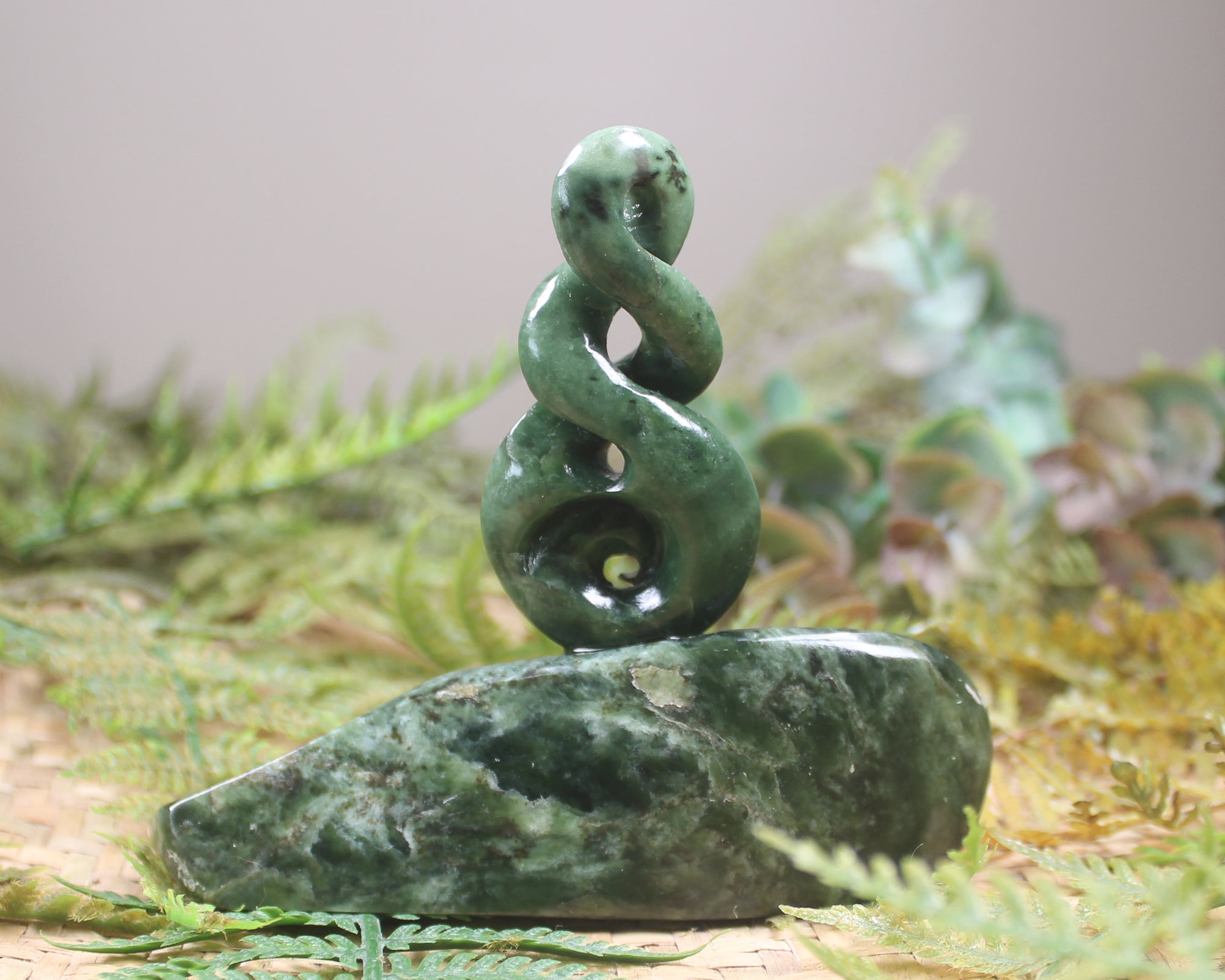 Kawakawa Pounamu Koru Twist set on a Pounamu base - NZ Greenstone