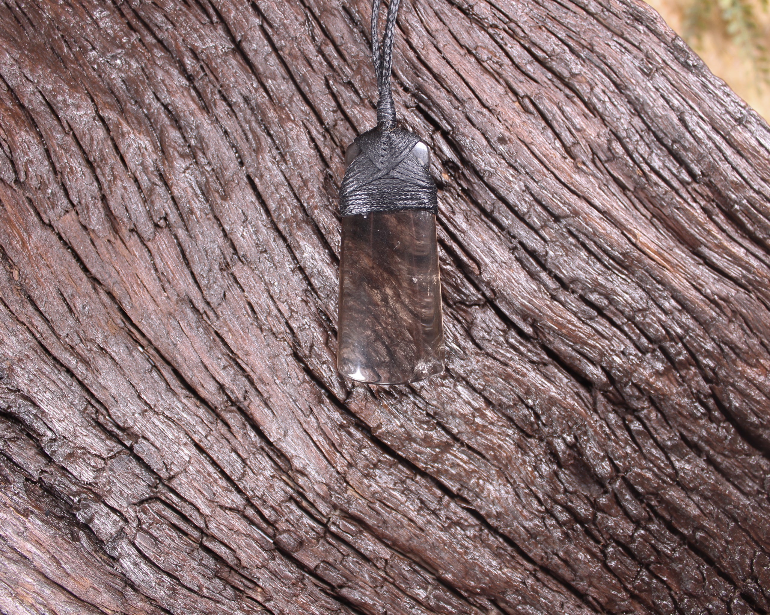 Toki pendant carved from Smokey Quartz