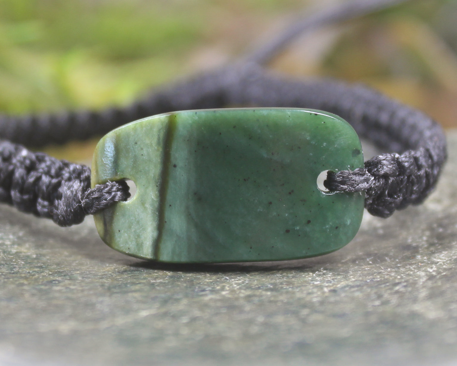 Adjustable cord bracelet with Kawakawa Pounamu