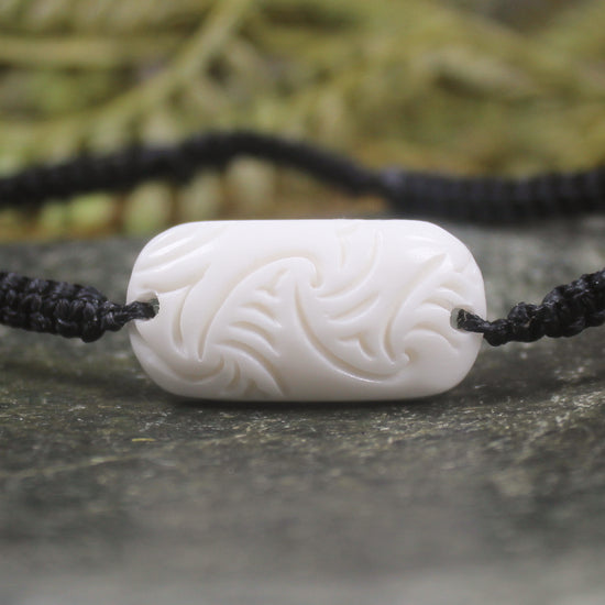 Adjustable cord bracelet with bone pendant