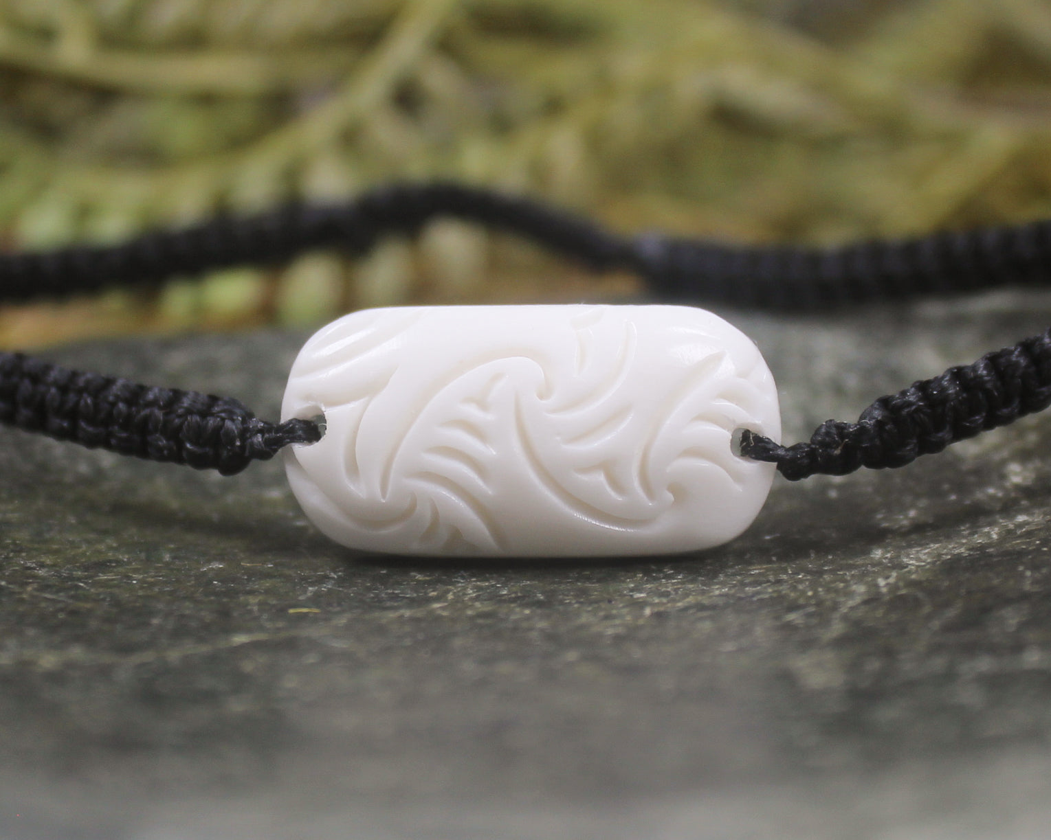 Adjustable cord bracelet with bone pendant