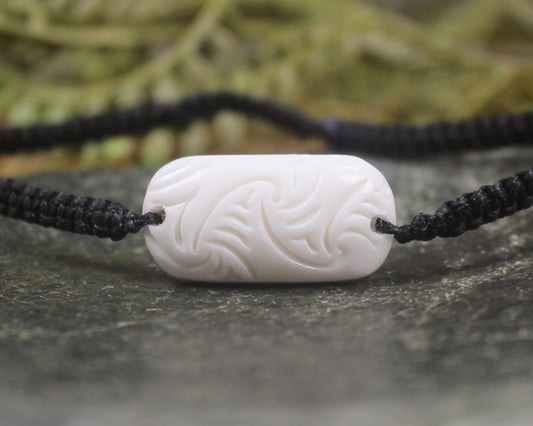 Adjustable cord bracelet with bone pendant