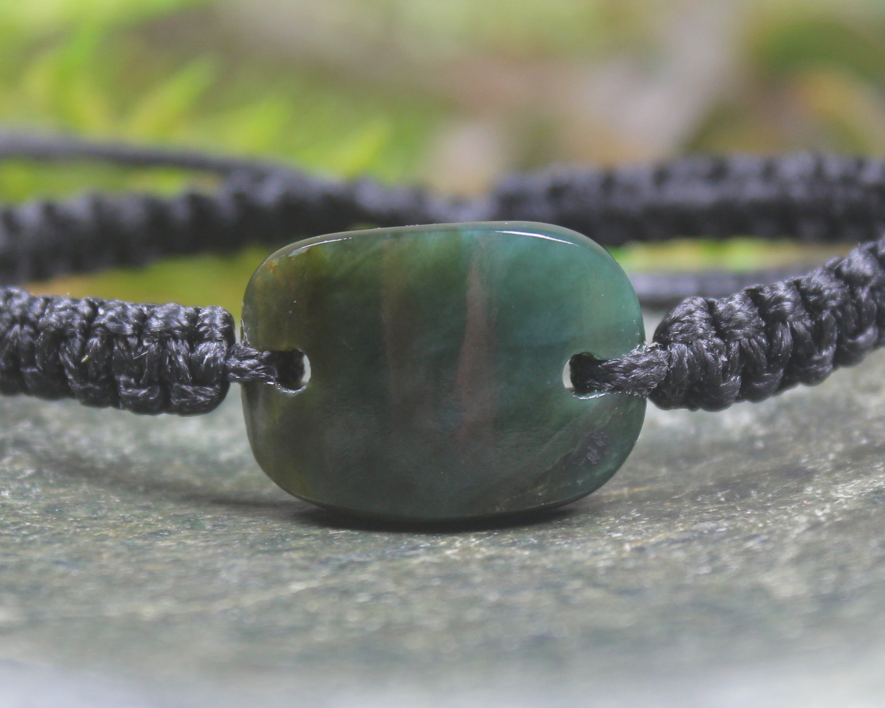 Adjustable cord bracelet with Inanga Pounamu