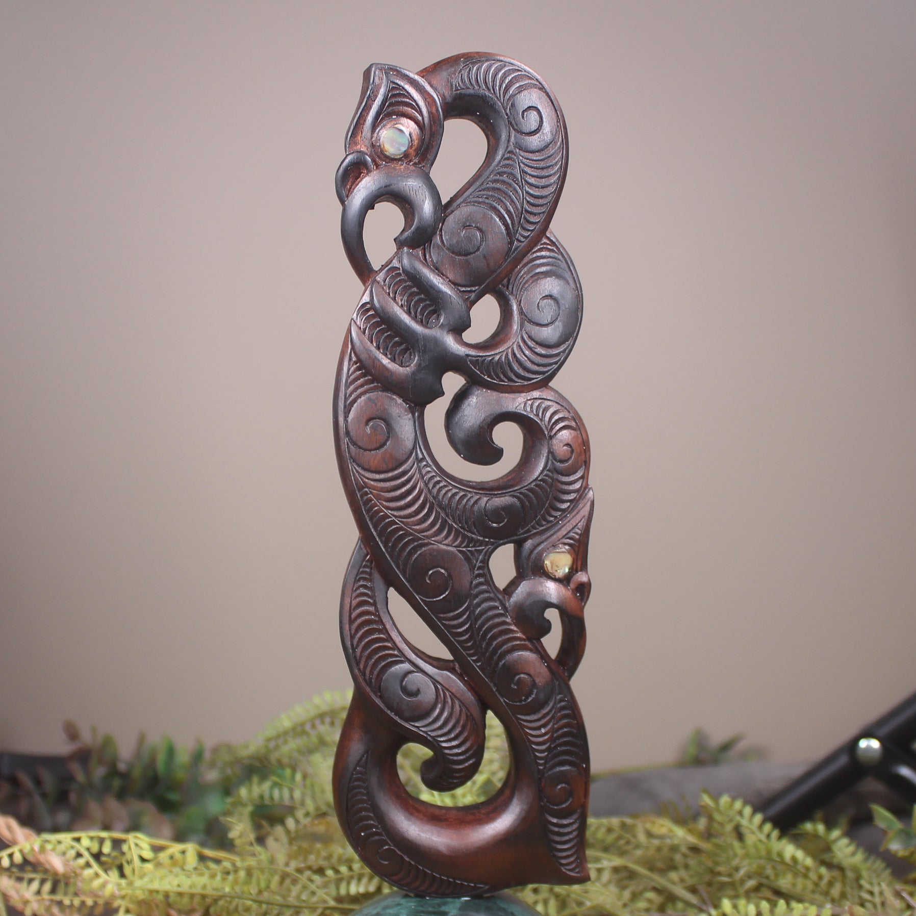 Manaia sculpture carved from recycled wood
