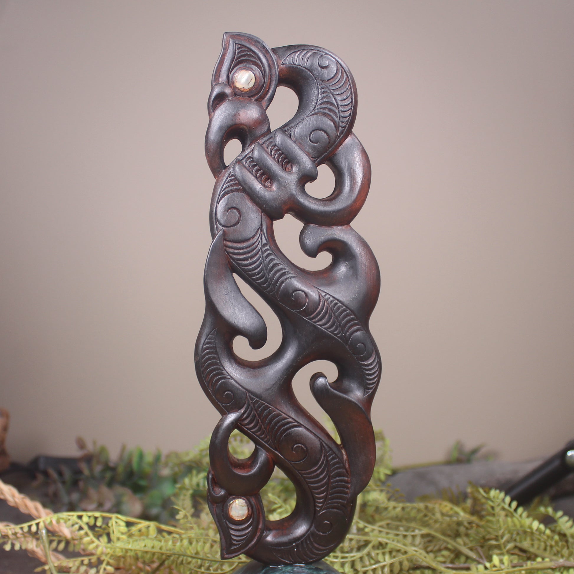 Manaia sculpture carved from recycled wood
