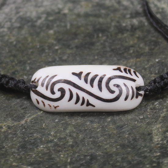 Adjustable cord bracelet with bone pendant