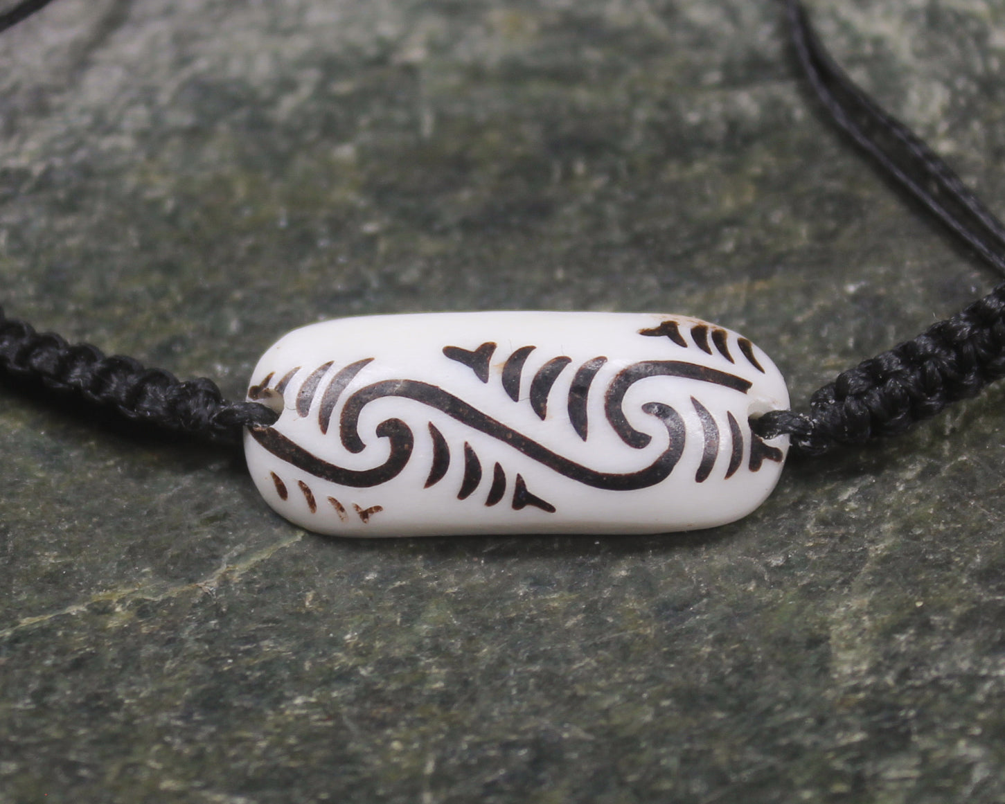 Adjustable cord bracelet with bone pendant