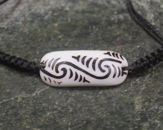 Adjustable cord bracelet with bone pendant