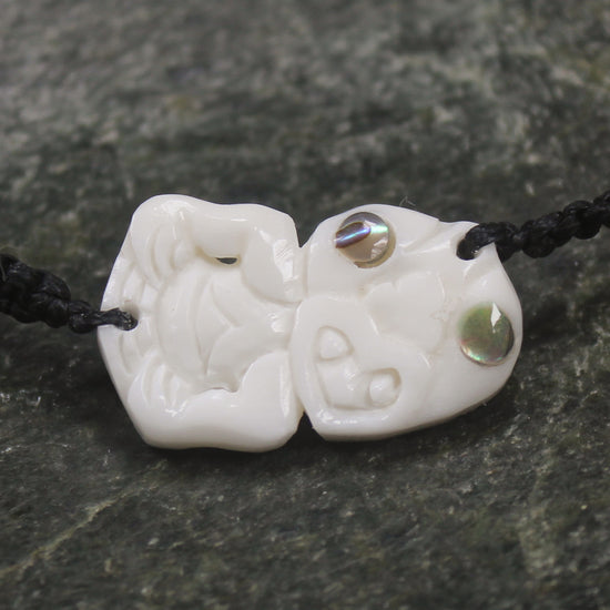 Adjustable cord bracelet with bone pendant