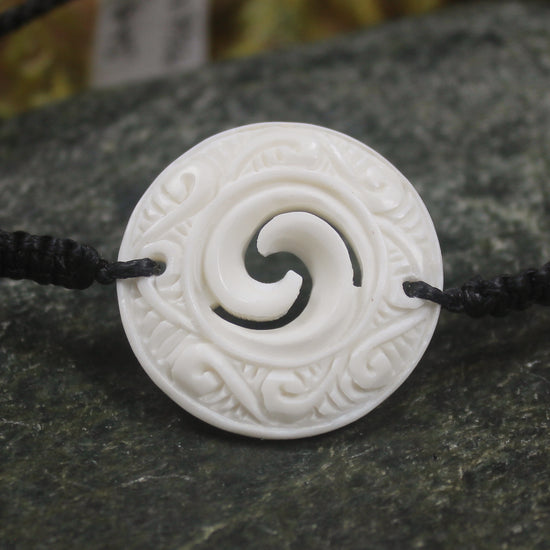 Adjustable cord bracelet with bone pendant