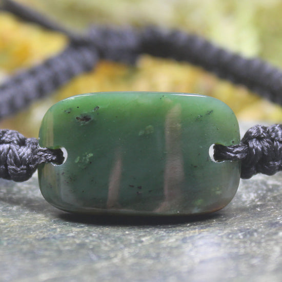 Adjustable cord bracelet with Kawakawa Pounamu