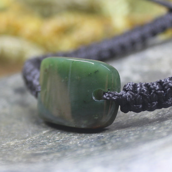Adjustable cord bracelet with Kawakawa Pounamu