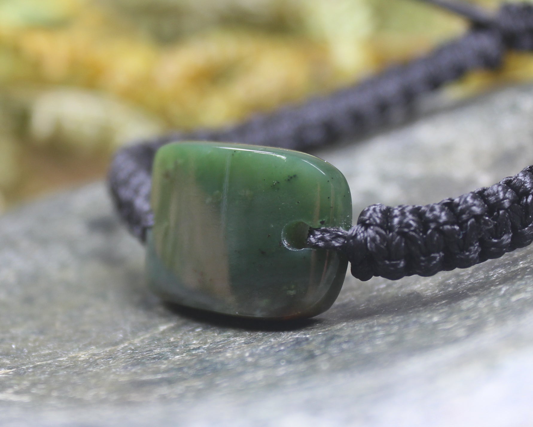 Adjustable cord bracelet with Kawakawa Pounamu