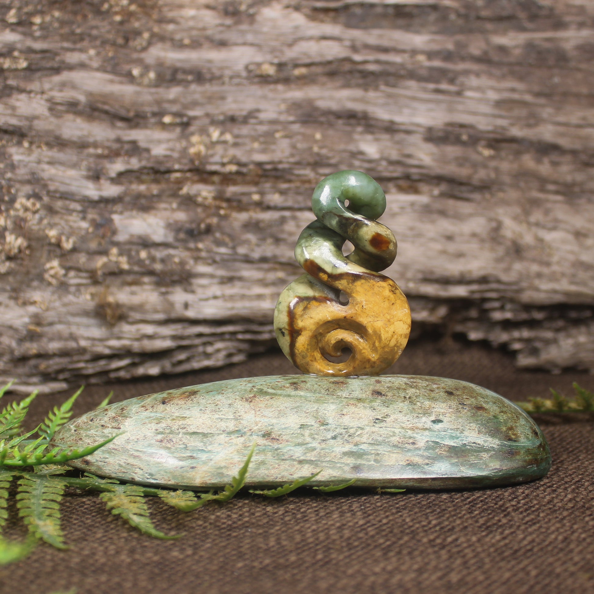 Flower Jade Pounamu Koru Twist set on a Pounamu base - NZ Greenstone
