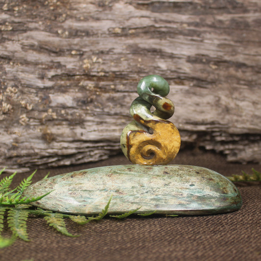 Flower Jade Pounamu Koru Twist set on a Pounamu base - NZ Greenstone