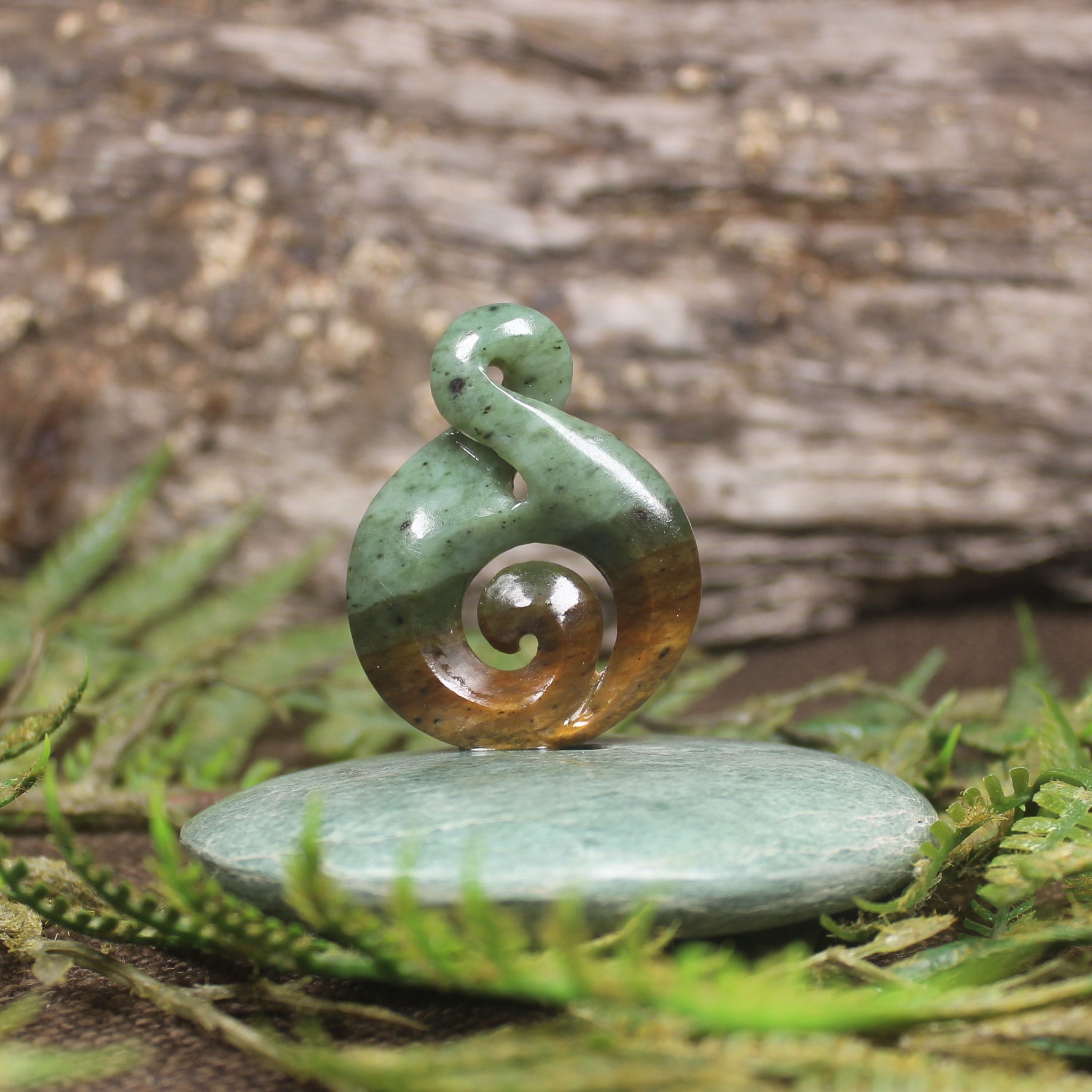 Flower Jade Pounamu Koru Twist set on a Pounamu base - NZ Greenstone