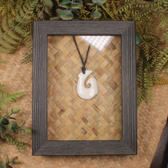 Bone Hei Matau pendant framed into a wall hanging
