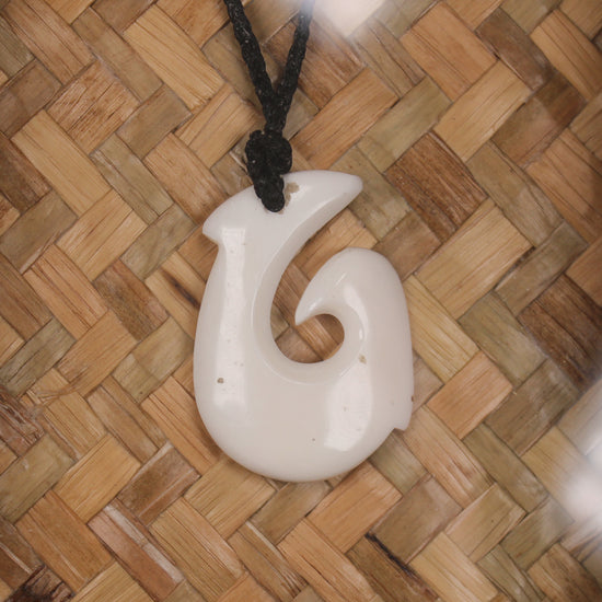 Bone Hei Matau pendant framed into a wall hanging