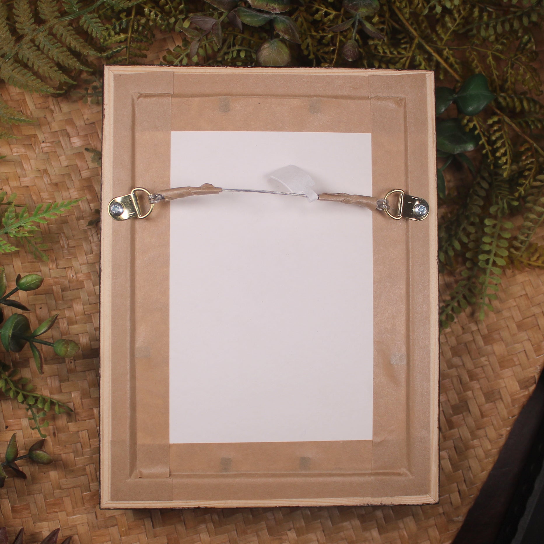 Bone Hei Matau pendant framed into a wall hanging
