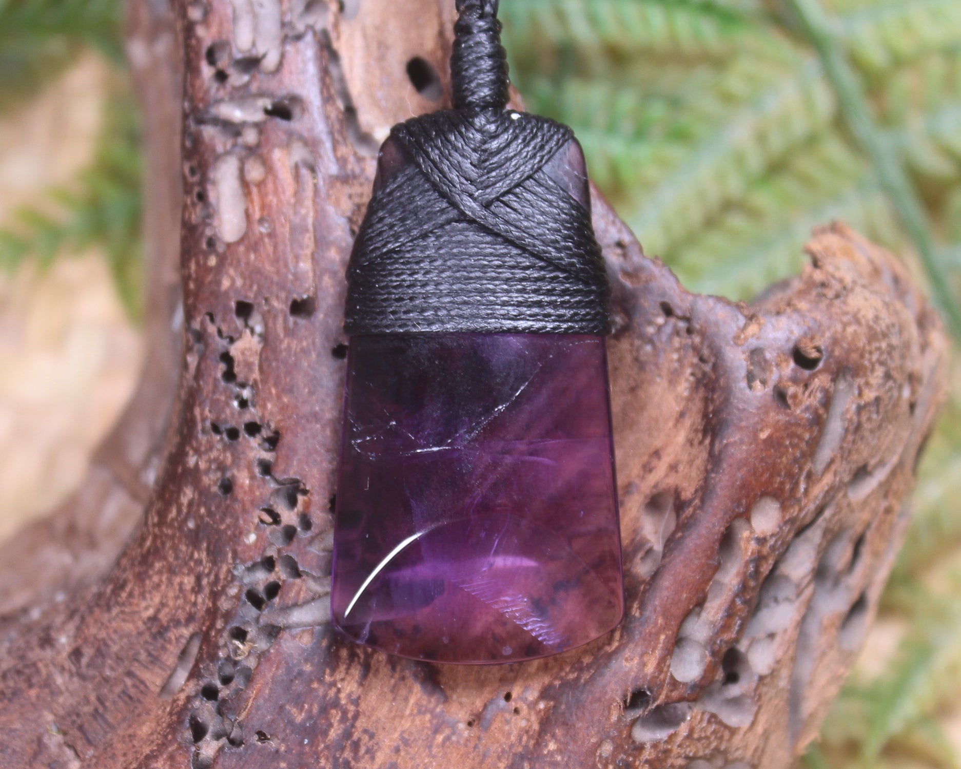 Toki pendant carved from Amethyst