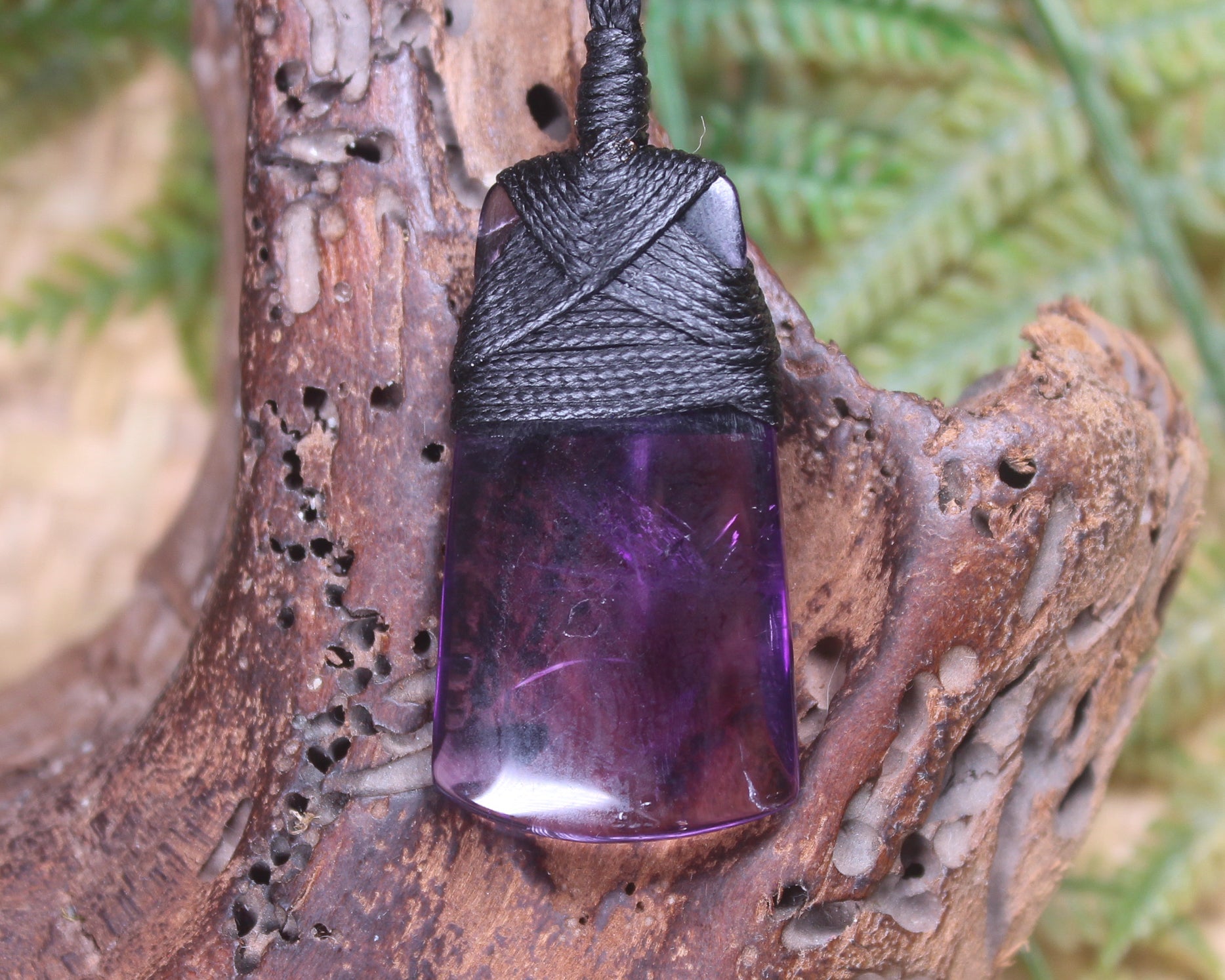 Toki pendant carved from Amethyst