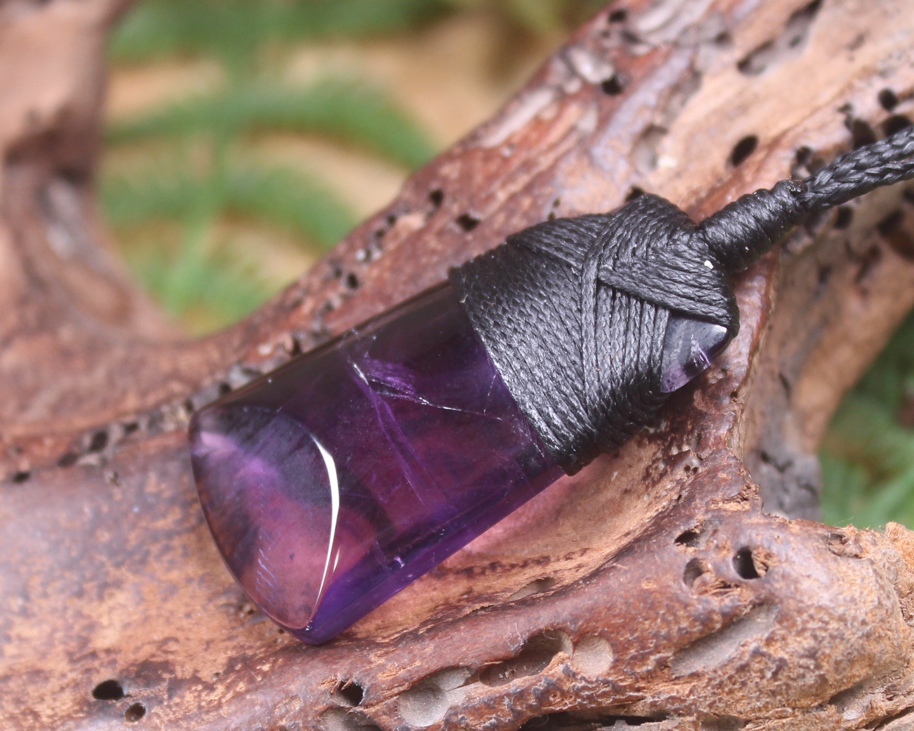 Toki pendant carved from Amethyst