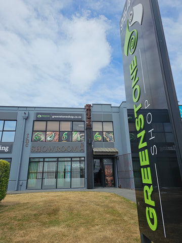 Greenstone Shop building with green signage against a blue sky